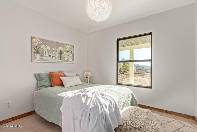 1060 S Kellis Rd, Wickenburg, AZ 85390 - tiled bedroom with baseboards and a chandelier
