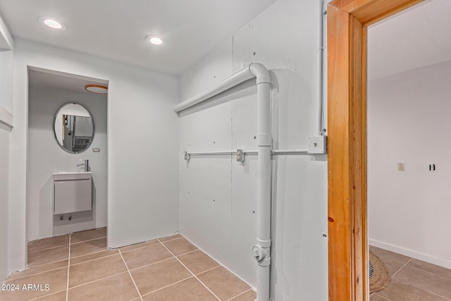 laundry room featuring tile patterned floors and sink