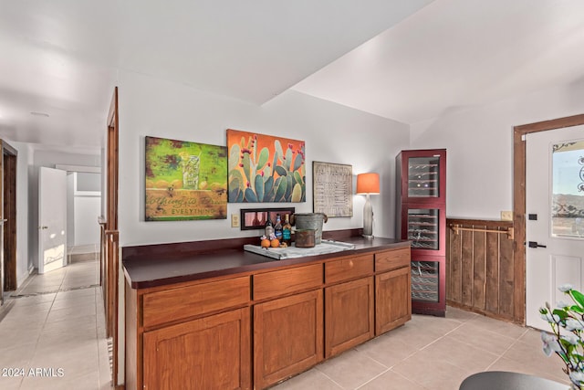 1060 S Kellis Rd, Wickenburg, AZ 85390 - kitchen featuring light tile patterned flooring, dark countertops, brown cabinets, and wainscoting