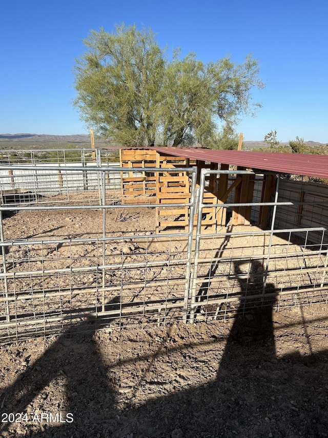 view of stable featuring a rural view