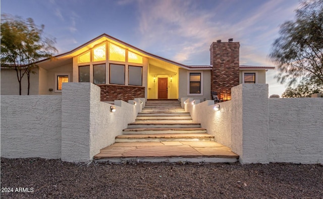 1060 S Kellis Rd, Wickenburg, AZ 85390 - view of front of house featuring stucco siding and a chimney