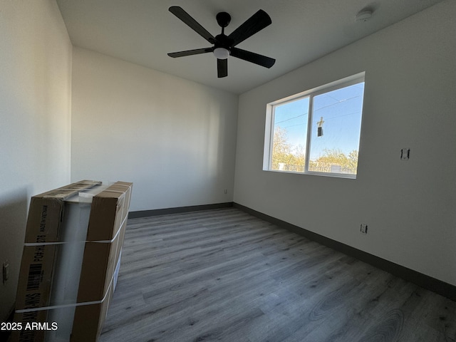 spare room featuring ceiling fan and wood-type flooring