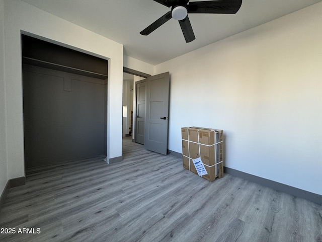 unfurnished bedroom featuring a closet, ceiling fan, and light hardwood / wood-style flooring