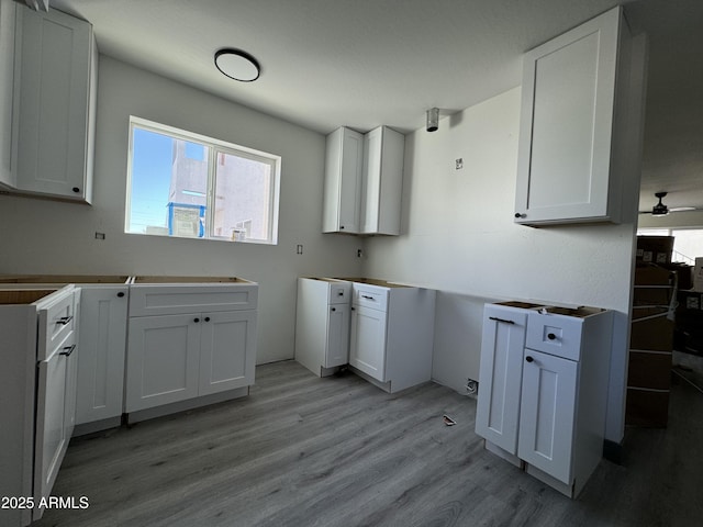 kitchen with white cabinetry and light hardwood / wood-style floors