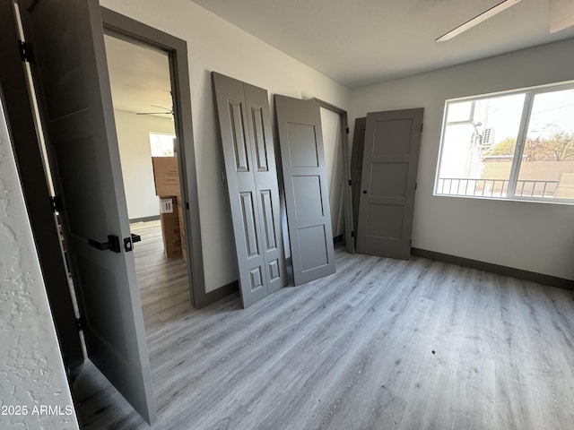 unfurnished bedroom featuring ceiling fan and light wood-type flooring