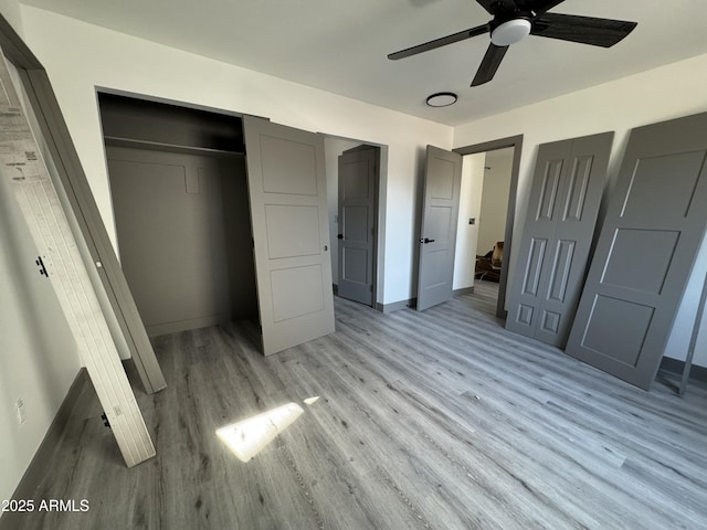 unfurnished bedroom featuring ceiling fan and light wood-type flooring