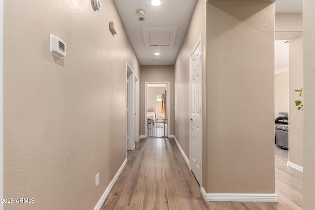 152 N 194th Ln, Buckeye, AZ 85326 - hallway with baseboards, light wood finished floors, attic access, and recessed lighting