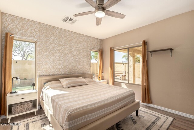 152 N 194th Ln, Buckeye, AZ 85326 - bedroom with baseboards, multiple windows, an accent wall, and wallpapered walls