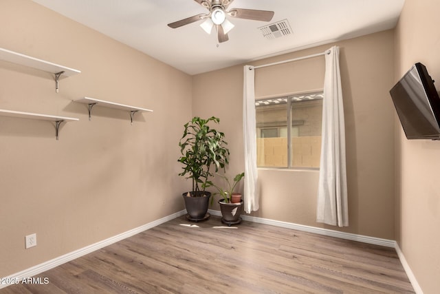 152 N 194th Ln, Buckeye, AZ 85326 - unfurnished room with visible vents, ceiling fan, wood finished floors, and baseboards