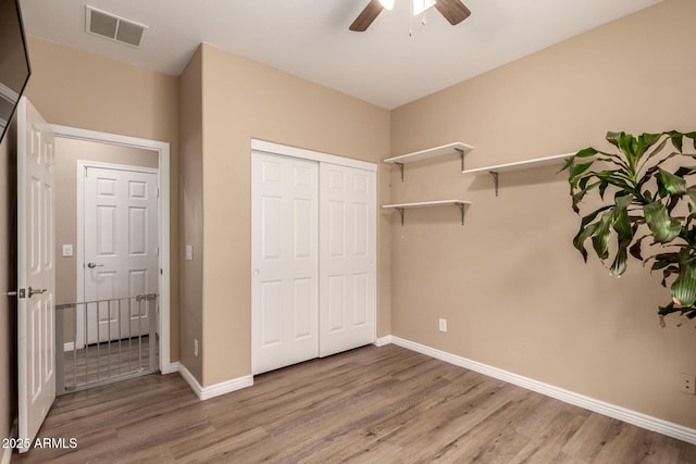 152 N 194th Ln, Buckeye, AZ 85326 - unfurnished bedroom with visible vents, baseboards, a closet, and wood finished floors