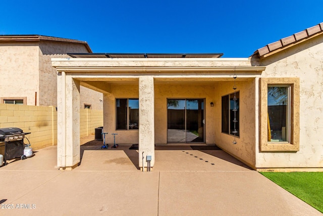 152 N 194th Ln, Buckeye, AZ 85326 - back of house featuring central AC unit, a patio area, stucco siding, and fence