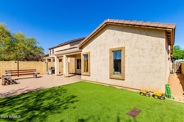 152 N 194th Ln, Buckeye, AZ 85326 - rear view of house featuring a patio area, a fenced backyard, a lawn, and stucco siding