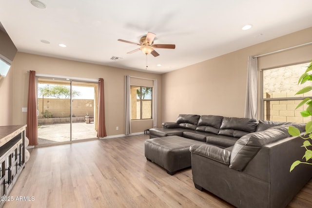 152 N 194th Ln, Buckeye, AZ 85326 - living room featuring light wood finished floors, a ceiling fan, visible vents, and recessed lighting
