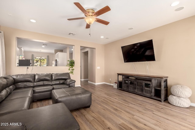 152 N 194th Ln, Buckeye, AZ 85326 - living room featuring wood finished floors, baseboards, a ceiling fan, and recessed lighting