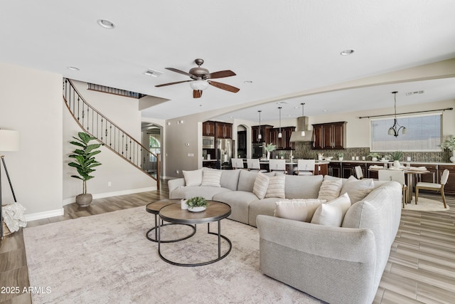 10331 E Starion Ave, Mesa, AZ 85212 - living area featuring a ceiling fan, arched walkways, light wood-style flooring, recessed lighting, and stairs