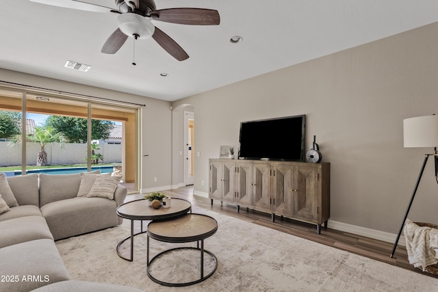10331 E Starion Ave, Mesa, AZ 85212 - living area featuring arched walkways, light wood-style floors, recessed lighting, and a ceiling fan
