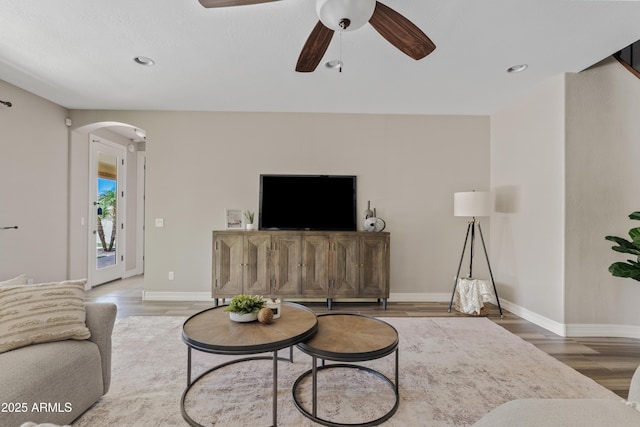 10331 E Starion Ave, Mesa, AZ 85212 - living area with arched walkways, wood finished floors, a ceiling fan, and recessed lighting
