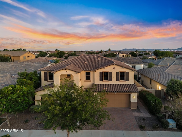 10331 E Starion Ave, Mesa, AZ 85212 - mediterranean / spanish house with a tile roof, stucco siding, an attached garage, driveway, and a residential view