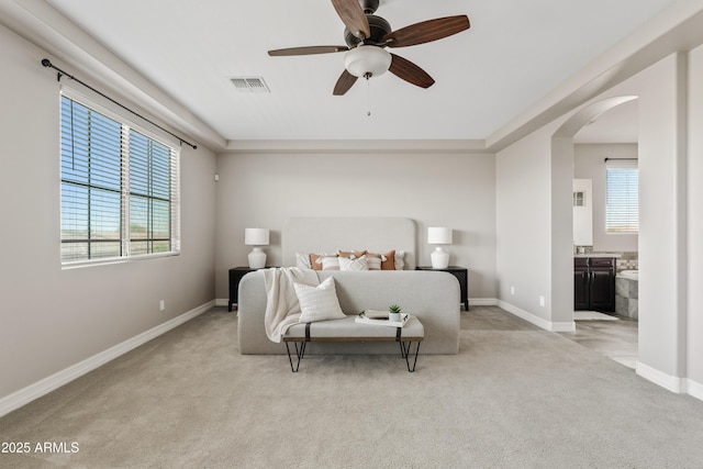 10331 E Starion Ave, Mesa, AZ 85212 - bedroom featuring light colored carpet, arched walkways, connected bathroom, and ceiling fan