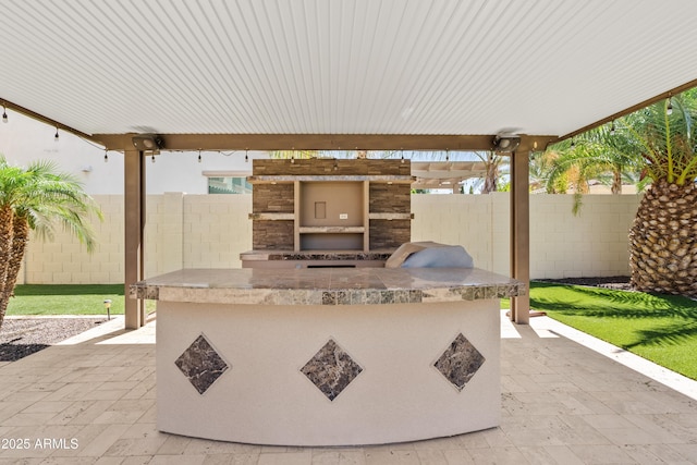 10331 E Starion Ave, Mesa, AZ 85212 - fenced backyard with an outdoor kitchen and a patio