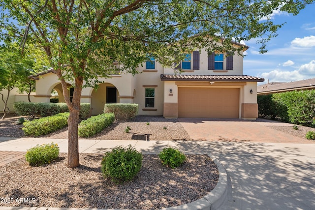 10331 E Starion Ave, Mesa, AZ 85212 - mediterranean / spanish-style house featuring stucco siding, decorative driveway, a tile roof, and a garage