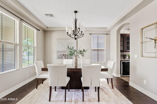 10331 E Starion Ave, Mesa, AZ 85212 - dining space with a chandelier, wood finished floors, wine cooler, and a raised ceiling