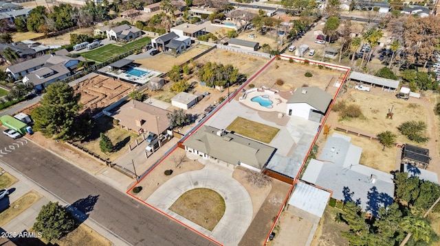 aerial view of residential area with property parcel outlined and a pool area