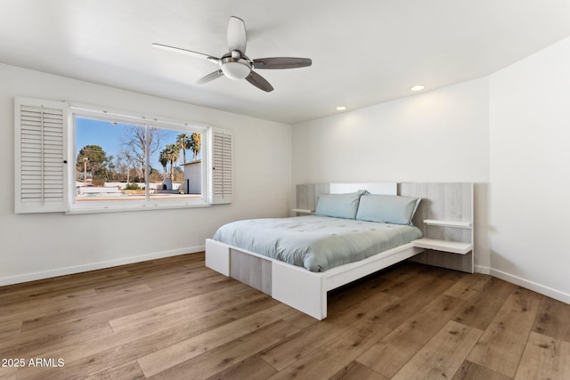 bedroom with ceiling fan and light hardwood / wood-style flooring