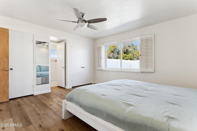 bedroom with light hardwood / wood-style flooring and ceiling fan