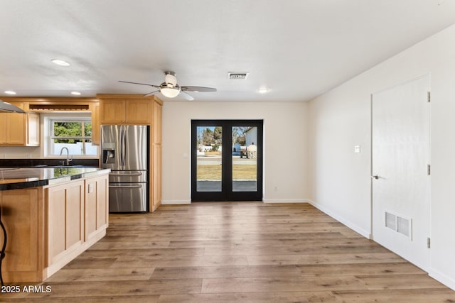 kitchen featuring light hardwood / wood-style floors, sink, light brown cabinetry, and stainless steel fridge with ice dispenser