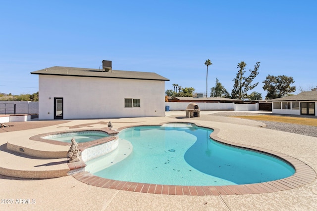 view of pool featuring an in ground hot tub and a patio