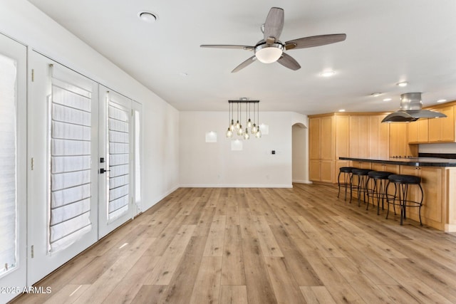 living room with a healthy amount of sunlight, light hardwood / wood-style flooring, and ceiling fan