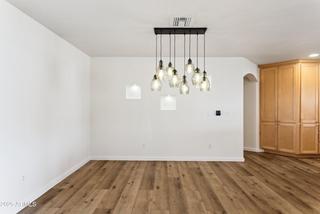 unfurnished dining area with hardwood / wood-style flooring