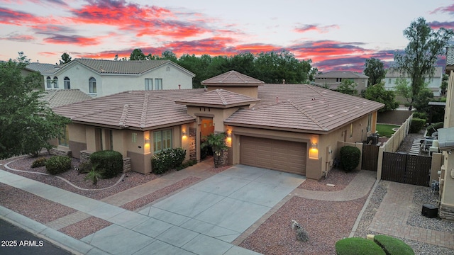 4756 E Ironhorse Rd, Gilbert, AZ 85297 - view of front of house featuring stucco siding, a garage, a gate, fence, and a tiled roof