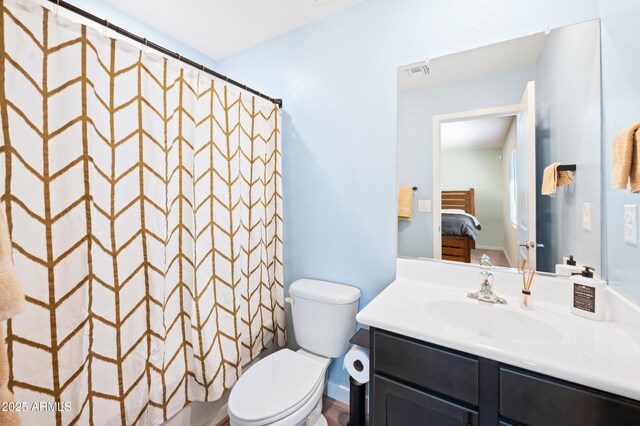 bathroom with vanity, curtained shower, and toilet