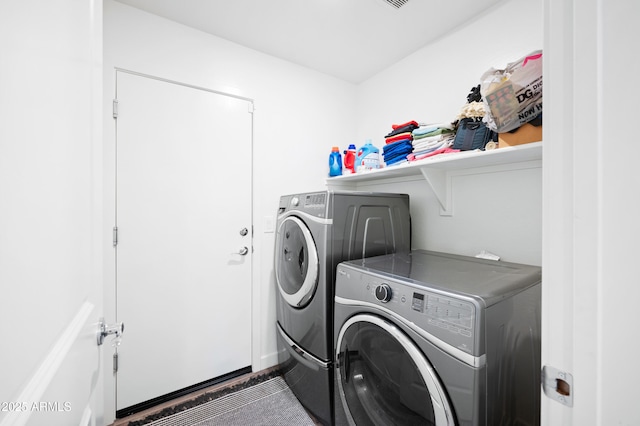 washroom with washing machine and clothes dryer