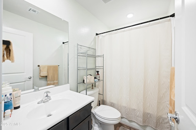 bathroom featuring vanity, toilet, and curtained shower