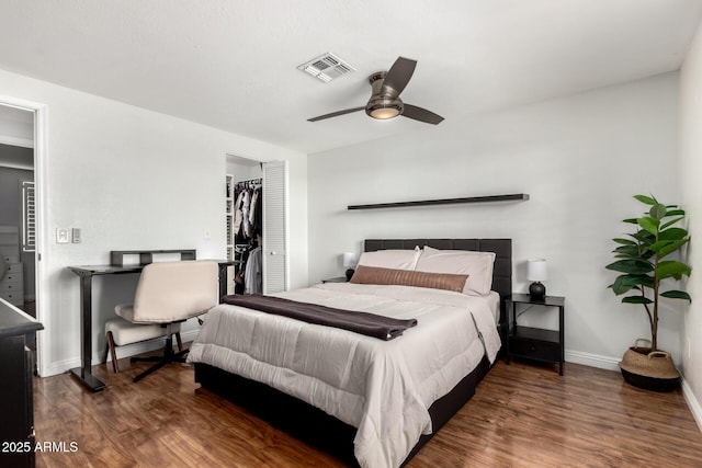 bedroom featuring baseboards, visible vents, a closet, and wood finished floors