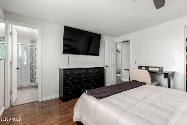 bedroom with baseboards, connected bathroom, and wood finished floors