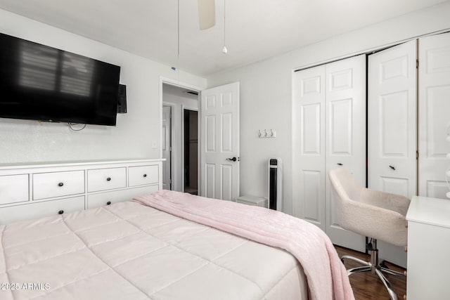 bedroom featuring a closet, wood finished floors, and ceiling fan