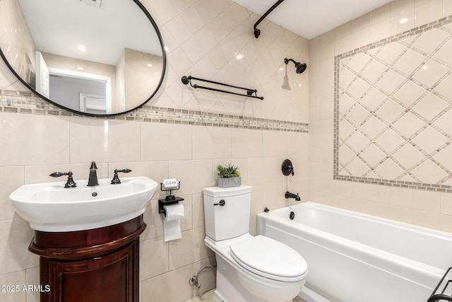 full bathroom with vanity, tile walls, toilet, bathing tub / shower combination, and visible vents
