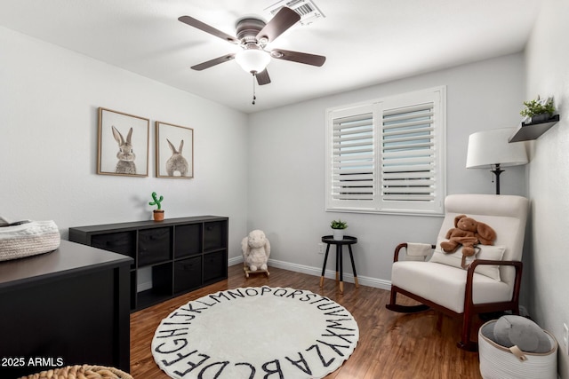 sitting room featuring baseboards, visible vents, wood finished floors, and a ceiling fan