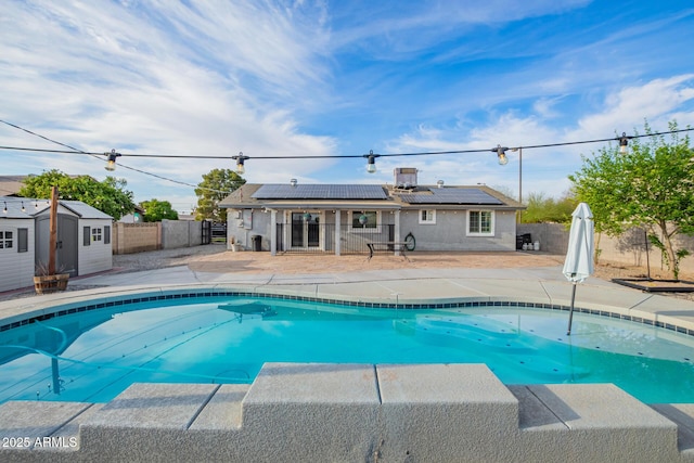 view of pool featuring a patio area, a fenced in pool, a shed, an outdoor structure, and a fenced backyard