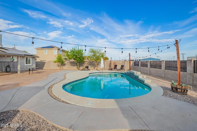 view of swimming pool featuring a patio, a fenced in pool, and a fenced backyard