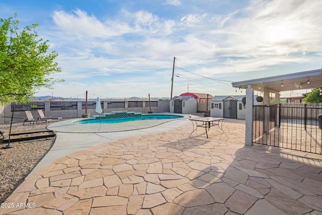 view of pool featuring an outdoor structure, fence, and a patio