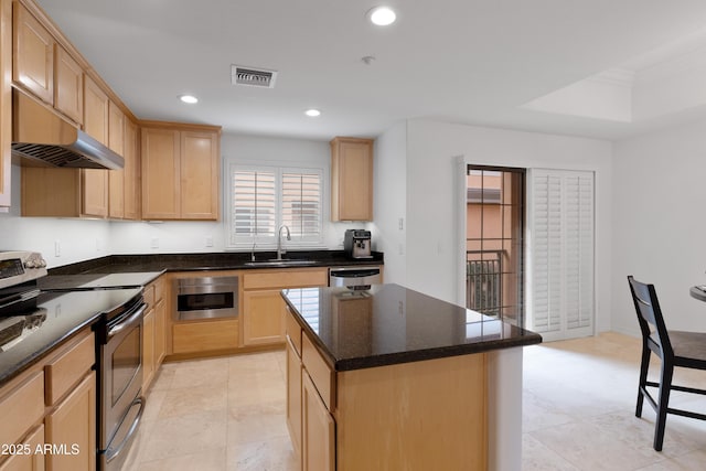 kitchen featuring sink, stainless steel electric range oven, dishwasher, a kitchen island, and light brown cabinets