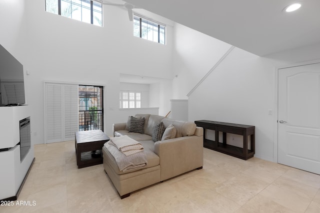 living room with a high ceiling and plenty of natural light