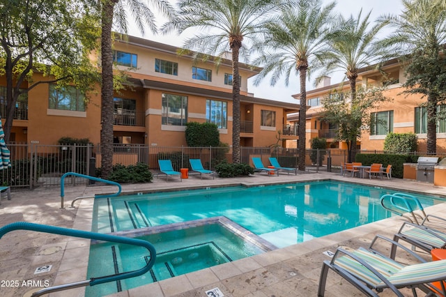 view of pool with a community hot tub, grilling area, and a patio