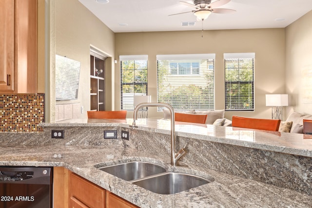 kitchen featuring sink, tasteful backsplash, plenty of natural light, and dishwashing machine