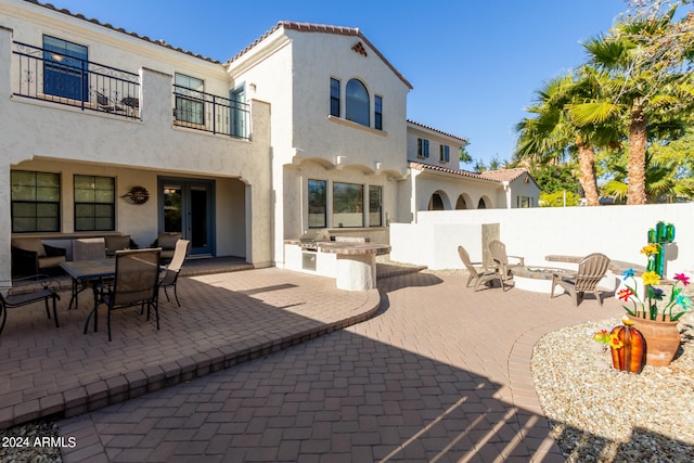 view of patio featuring a grill, a balcony, and area for grilling